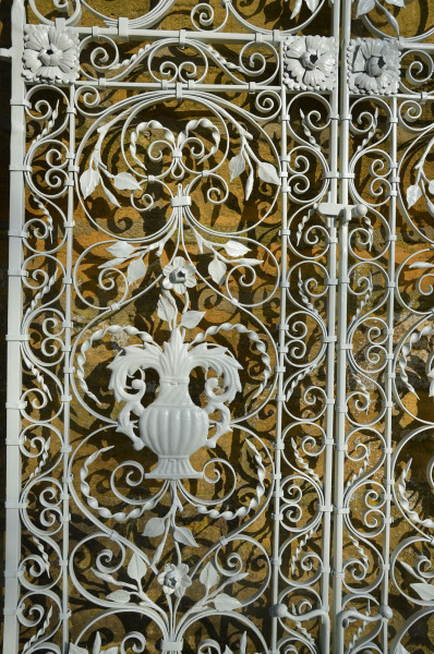A pair of ornate wrought iron garden gates