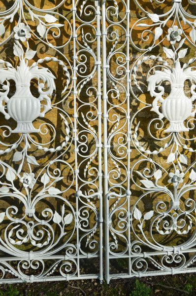 A pair of ornate wrought iron garden gates