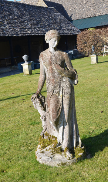 A 19th Century composition stone garden figure of Flora by Austin and Seeley