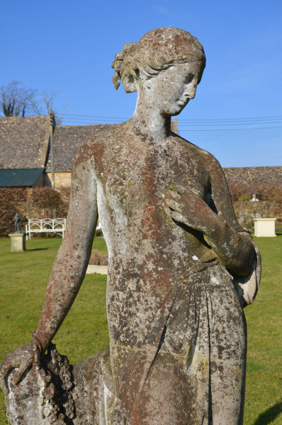 A 19th Century composition stone garden figure of Flora by Austin and Seeley