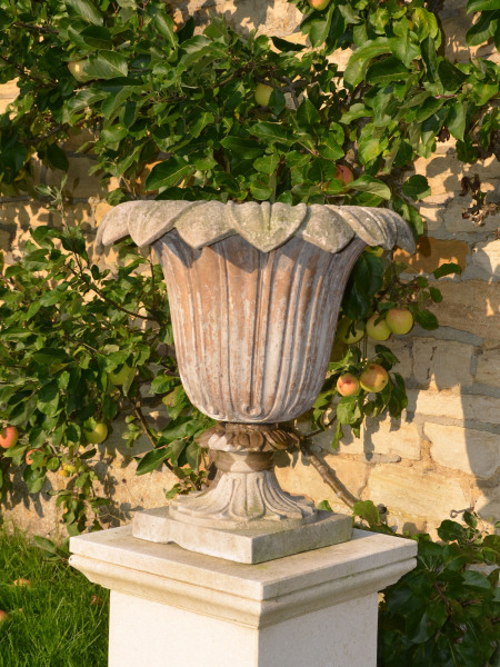 A pair of Austin and Seeley composition stone urns