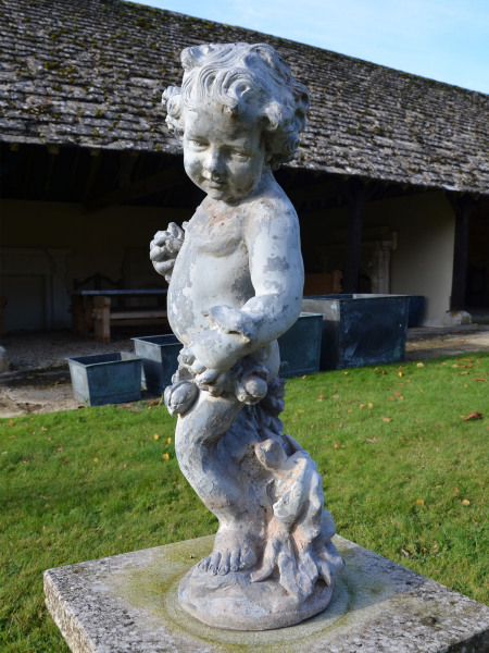 A lead figure depicting Summer as a cherub 
