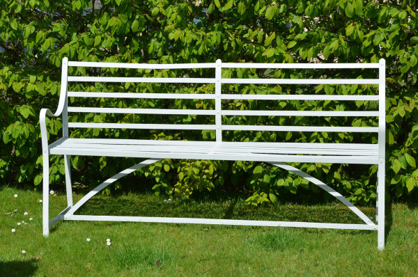 A wrought iron garden bench