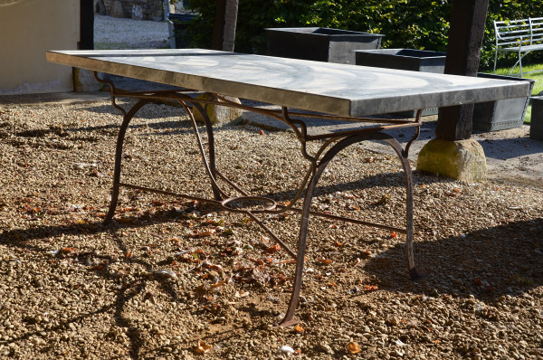 A wrought iron table base with solid Italian Arabesque marble top 
