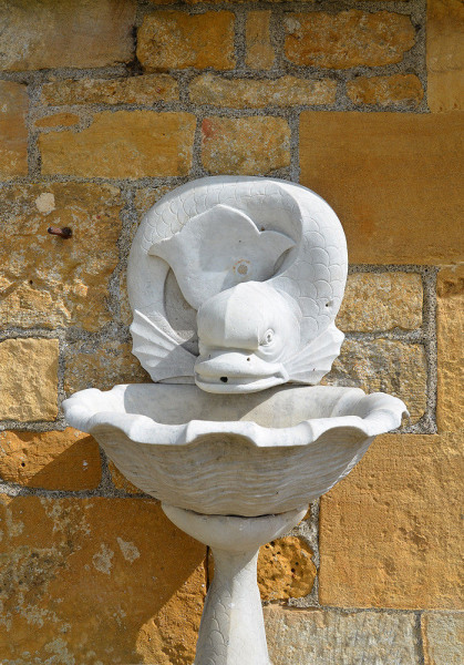 An early 20th century white marble wall fountain