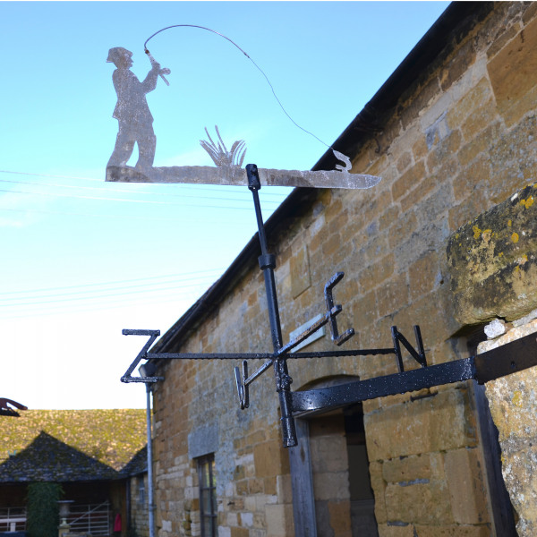 A vintage cut zinc weathervane of a fisherman in action!