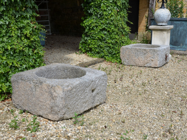 A pair of square granite planters