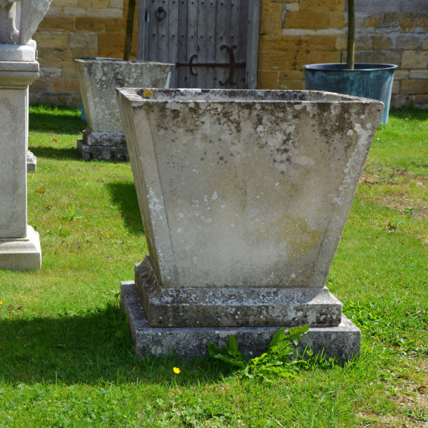 A pair of mid 20th century square stone planters of taper form 