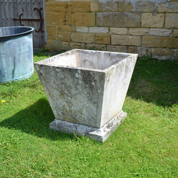 A pair of mid 20th century square stone planters of taper form 