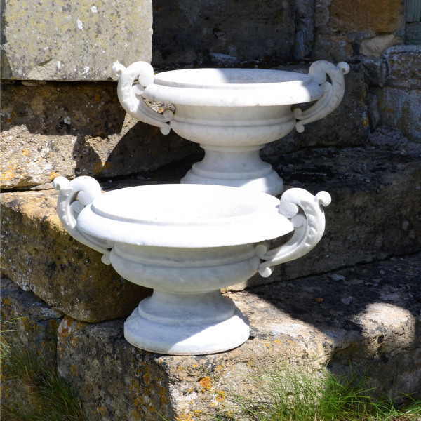 A small pair of marble urns of tazza form with scroll handles