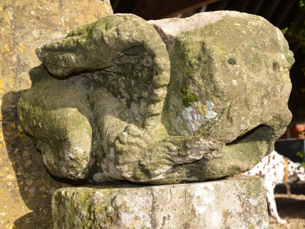 A large medieval carved limestone long fingered mouth puller gargoyle