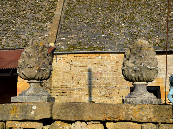 A pair of carved Bath stone pineapple finials