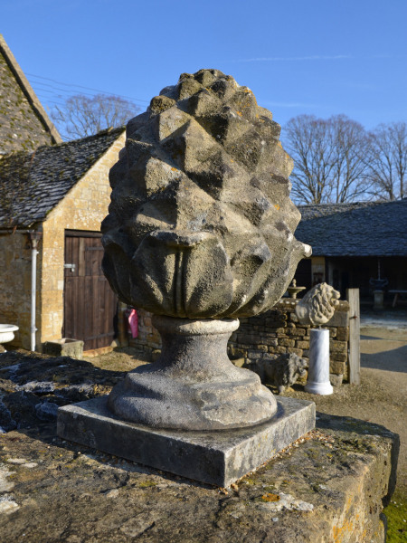 A pair of carved Bath stone pineapple finials