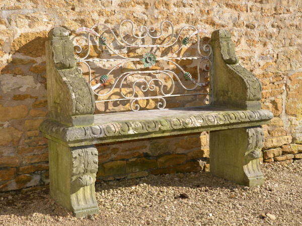 An early 20th century carved limestone garden seat