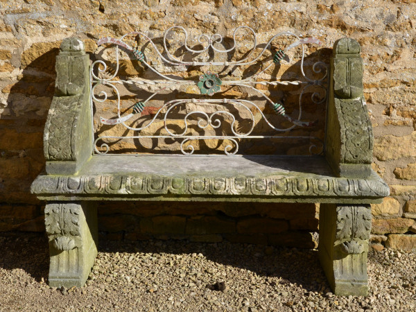 An early 20th century carved limestone garden seat