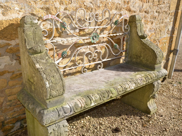 An early 20th century carved limestone garden seat