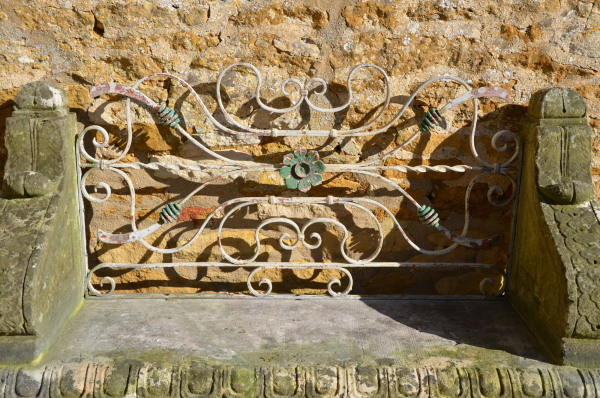 An early 20th century carved limestone garden seat