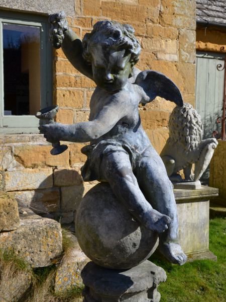 A pair of early 20th century winged lead putti