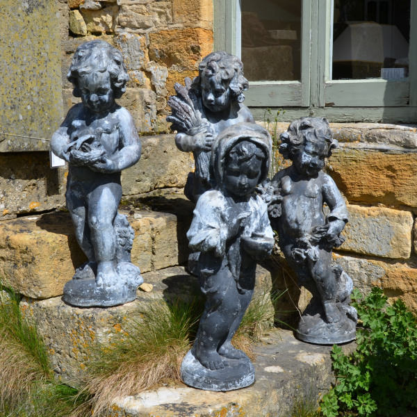 A set of four large lead Seasons