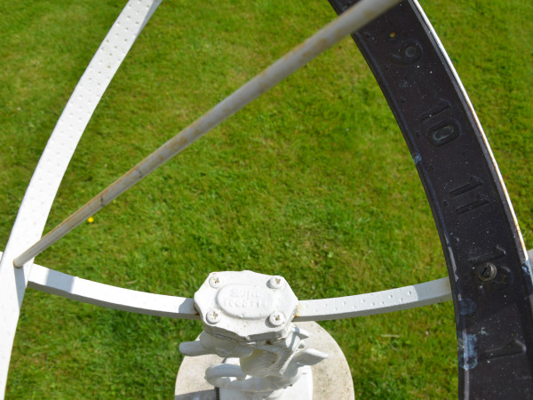 A 20th century Bath stone sundial base surmounted by a Swedish Armillary with sea horse support designed by Sune Rooth