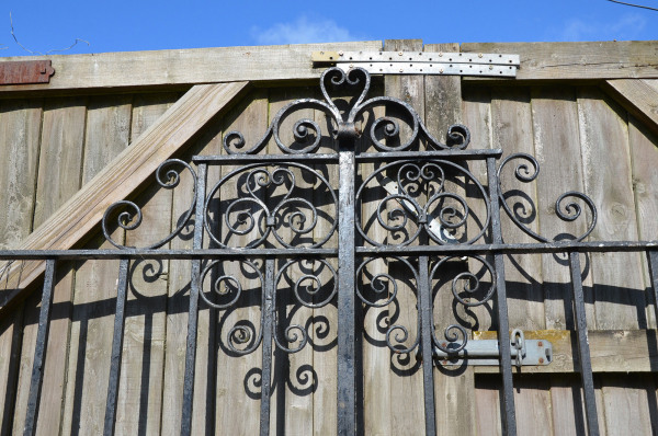 A pair of early 20th century wrought iron entrance gates