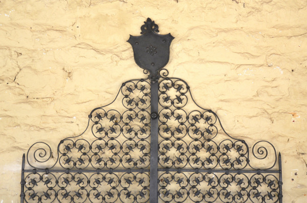 A pair of early 20th century wrought iron garden gates with shield