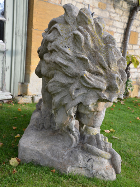 A large 19th century French composition stone Lion attacking a snake